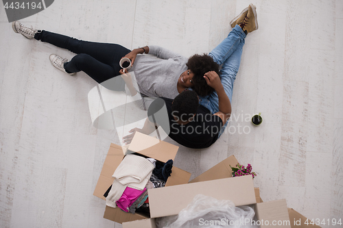 Image of African American couple relaxing in new house