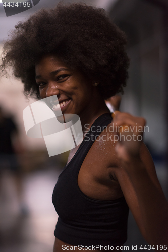 Image of black woman lifting empty bar