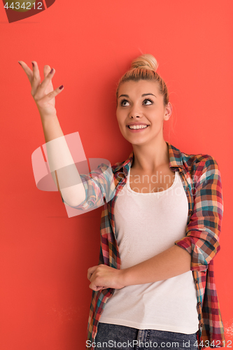 Image of woman over color background plays with apple