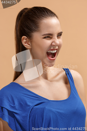 Image of The happy woman standing and smiling against pastel background.