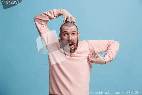 Image of Handsome man in stress isolated on blue