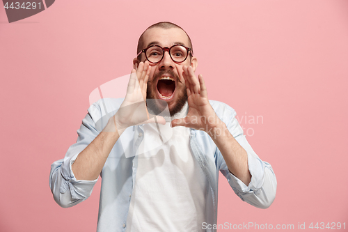 Image of Isolated on pink young casual man shouting at studio