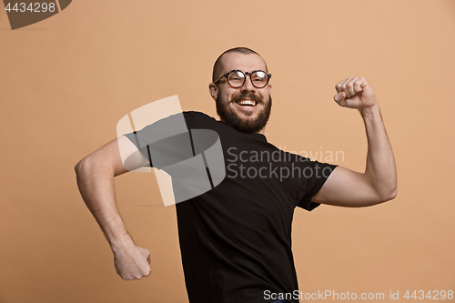 Image of Winning success man happy ecstatic celebrating being a winner. Dynamic energetic image of male model