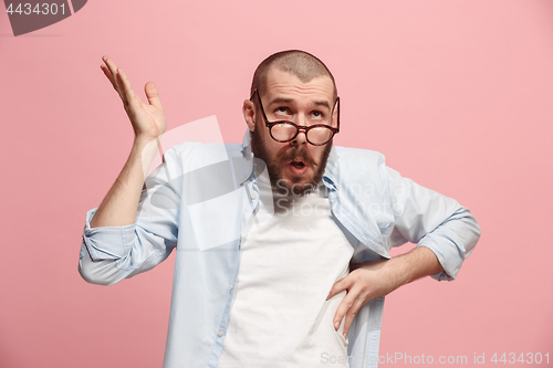 Image of Let me think. Doubtful pensive man with thoughtful expression making choice against pink background