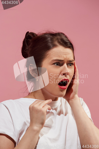 Image of Woman having headache. Isolated over pink background.