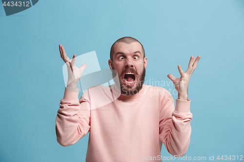 Image of Handsome man in stress isolated on blue