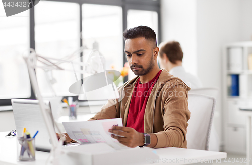 Image of indian man with laptop computer at office