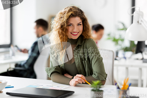 Image of creative woman working on user interface at office