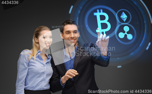 Image of businesspeople with cryptocurrency holograms