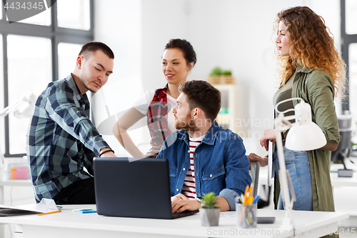Image of creative team with laptop working at office