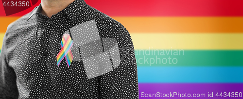 Image of man with gay pride rainbow awareness ribbon