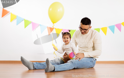 Image of father and daughter with birthday party balloon