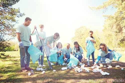 Image of volunteers with garbage bags cleaning park area