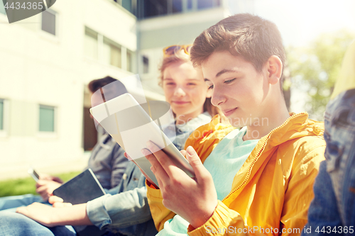 Image of happy friends or students with tablet pc outdoors