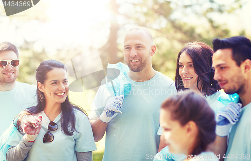 Image of volunteers with garbage bags walking outdoors