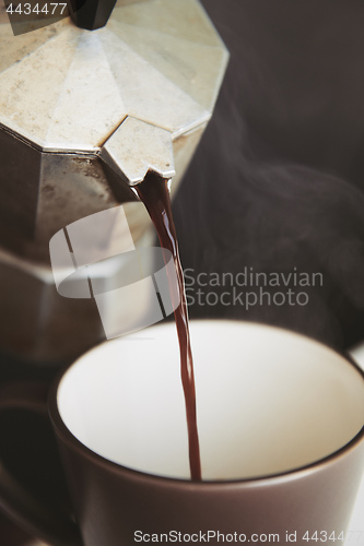 Image of Hot coffee is poured from mokacoffee maker