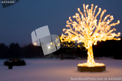 Image of Blurred composition. Gold lights Christmas Tree