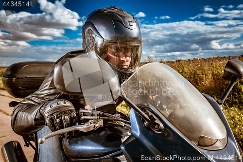 Image of Biker racing on the road