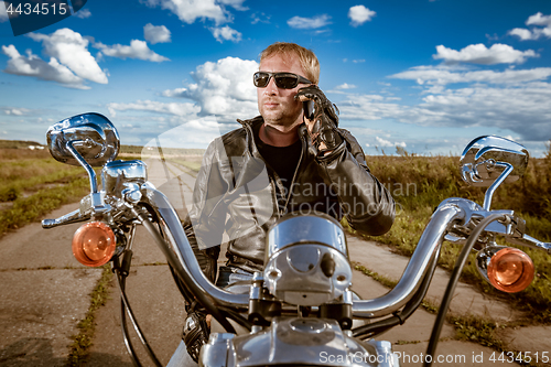 Image of Biker talking on a smartphone.