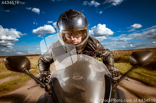 Image of Biker racing on the road