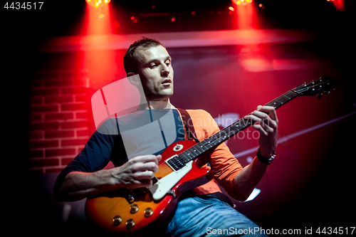 Image of Band performs on stage in a nightclub