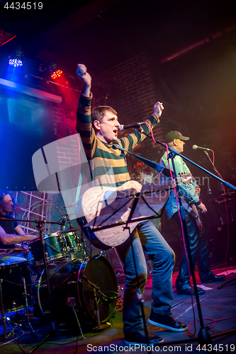 Image of Band performs on stage in a nightclub