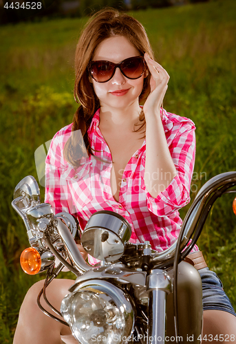 Image of Biker girl and motorcycle