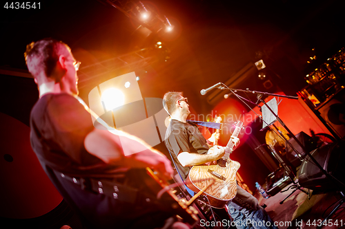 Image of Band performs on stage in a nightclub