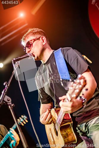 Image of Band performs on stage in a nightclub