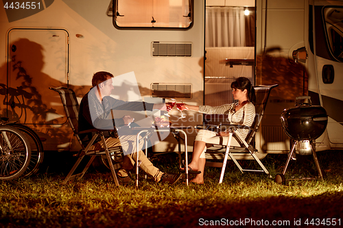 Image of Adult couple clinking glasses of wine. Family vacation travel RV