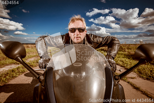 Image of Biker racing on the road