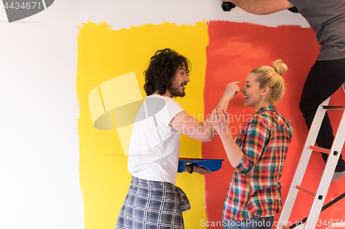 Image of couple painting interior wall