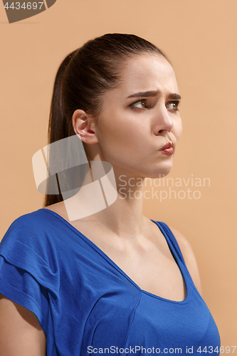 Image of Beautiful woman looking suprised and bewildered isolated on pastel