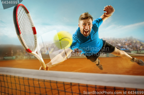 Image of The one jumping player, caucasian fit man, playing tennis on the earthen court with spectators