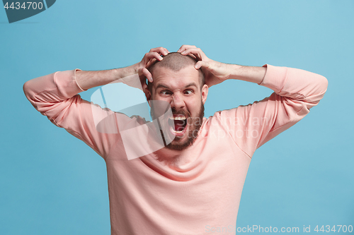 Image of Handsome man in stress isolated on blue