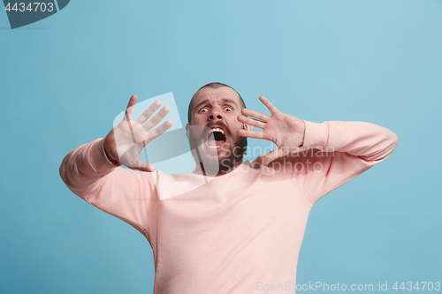 Image of Portrait of the scared man on blue