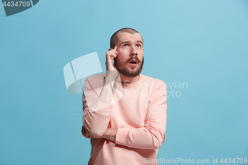 Image of Young serious thoughtful businessman. Doubt concept.