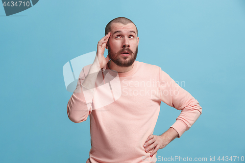 Image of Young serious thoughtful businessman. Doubt concept.