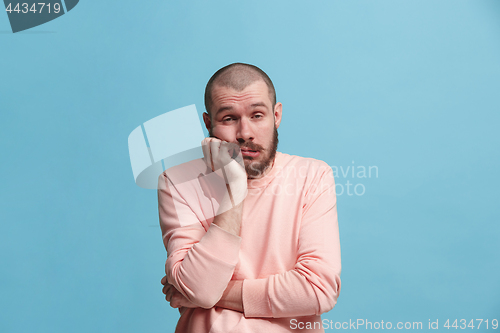 Image of Beautiful bored man bored isolated on blue background