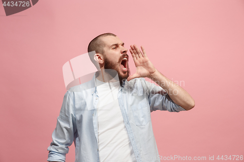 Image of Isolated on pink young casual man shouting at studio