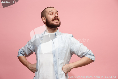 Image of The happy business man standing and smiling against pastel background.