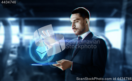 Image of businessman with tablet pc and ethereum hologram