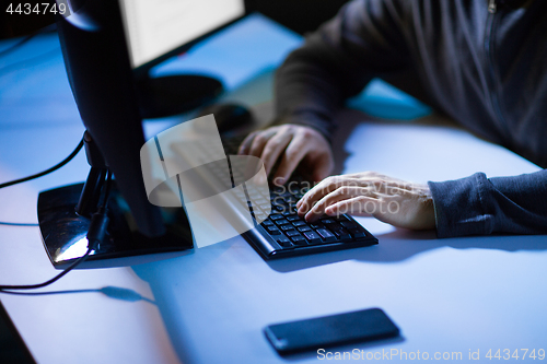 Image of hacker hands typing on computer keyboard