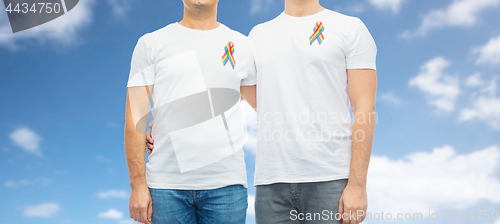 Image of close up of couple with gay pride rainbow ribbons