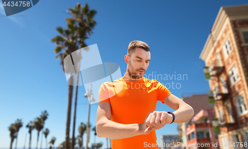 Image of man with fitness tracker training outdoors