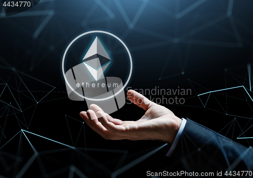 Image of businessman hand with ethereum over low poly