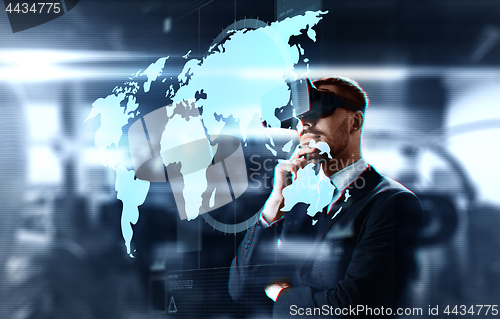 Image of businessman in virtual headset with world map