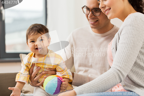 Image of happy family with baby daughter at home