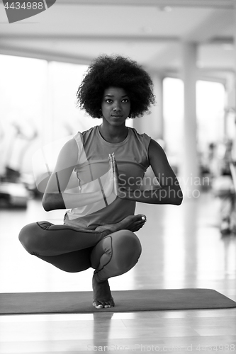 Image of african american woman exercise yoga in gym