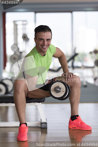 Image of handsome man working out with dumbbells